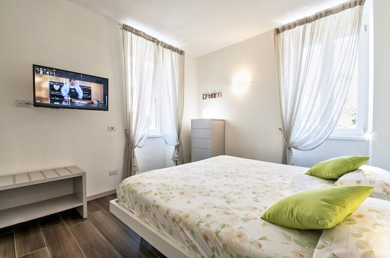 holiday apartment bedroom with double bed and TV